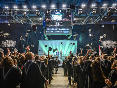 graduation caps being tossed