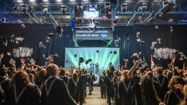 graduation caps being tossed